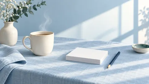 Tea, blank cards and a pencil in morning light